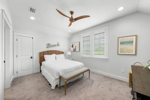 a bathroom with a double vanity sink toilet mirror and bathtub