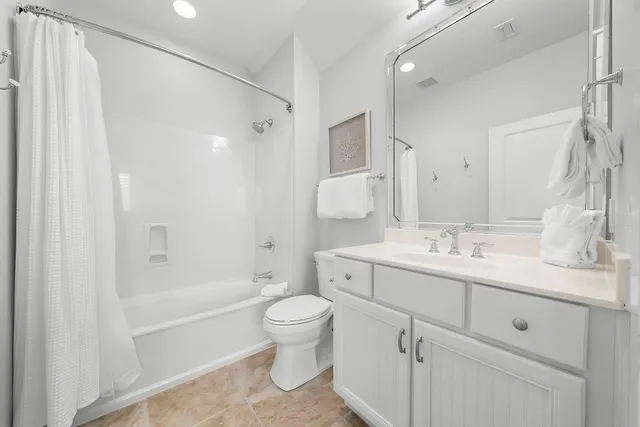 a bathroom with a double vanity sink toilet mirror and shower
