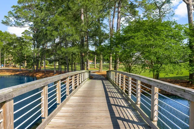 a view of balcony with wooden floor and fence
