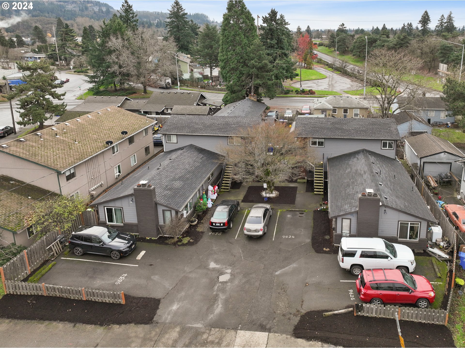 an aerial view of a house with a parking space