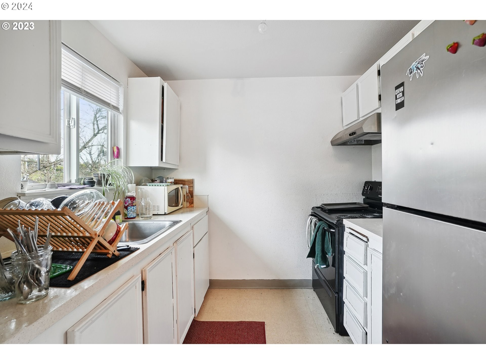 9630 Southeast Foster Road Portland, OR 97266 - Photo 26 of 33 a kitchen with a sink appliances and cabinets