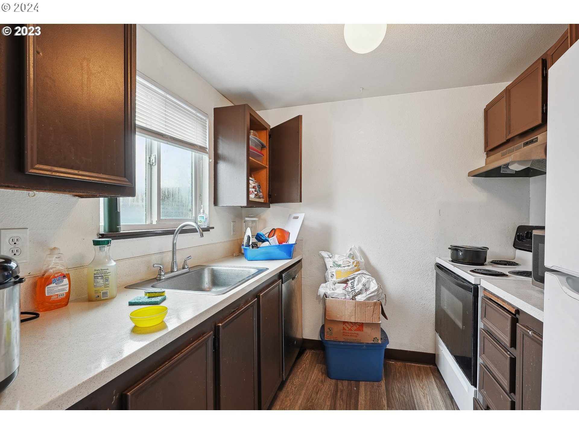 9630 Southeast Foster Road Portland, OR 97266 - Photo 4 of 33 a kitchen with a sink a stove and cabinets