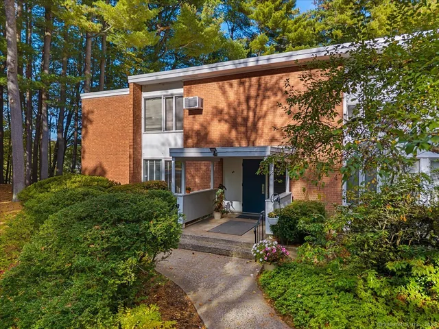 a view of house with backyard and garden