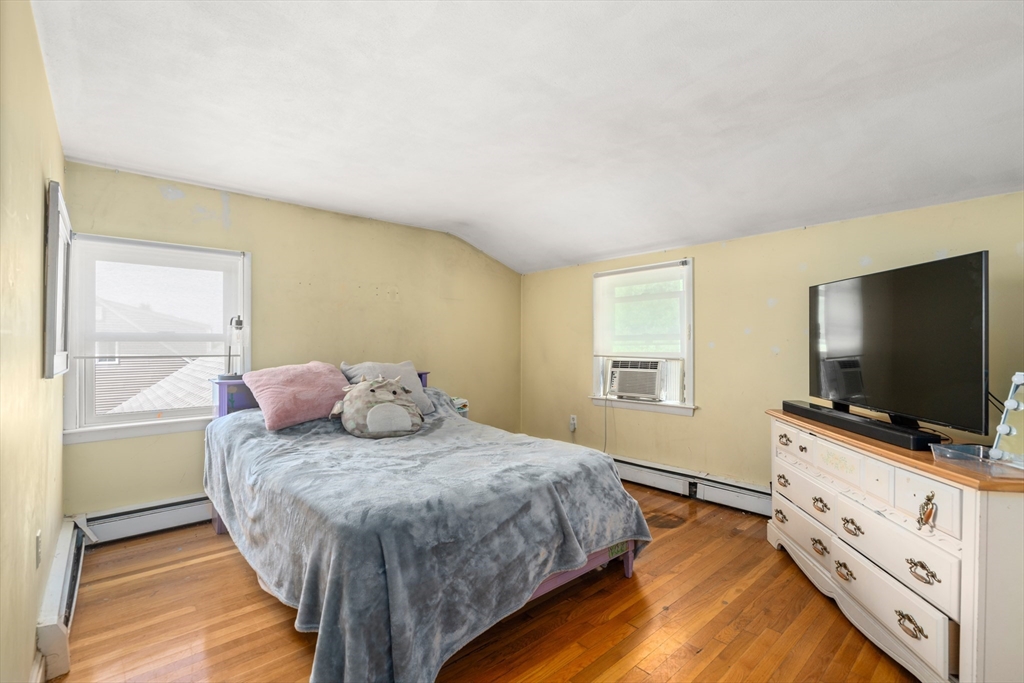 34 Irving Drive Walpole, MA 02081 - Photo 15 of 20 a bedroom with a bed and a flat screen tv