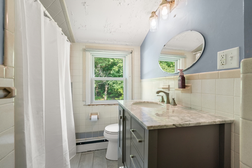 34 Irving Drive Walpole, MA 02081 - Photo 16 of 20 a bathroom with a granite countertop sink and a mirror