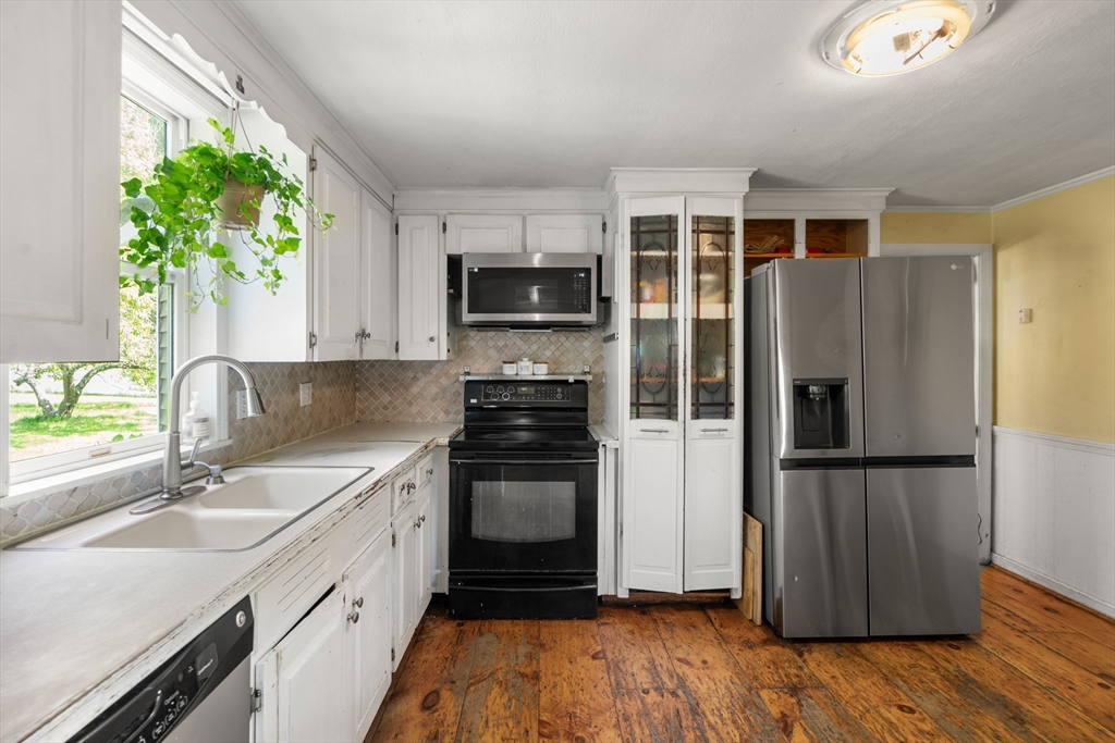 34 Irving Drive Walpole, MA 02081 - Photo 6 of 20 a kitchen with stainless steel appliances granite countertop a refrigerator a sink a stove a microwave and wooden floor