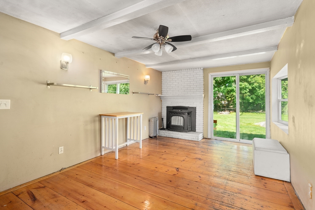 34 Irving Drive Walpole, MA 02081 - Photo 8 of 20 a view of empty room with wooden floor and fireplace