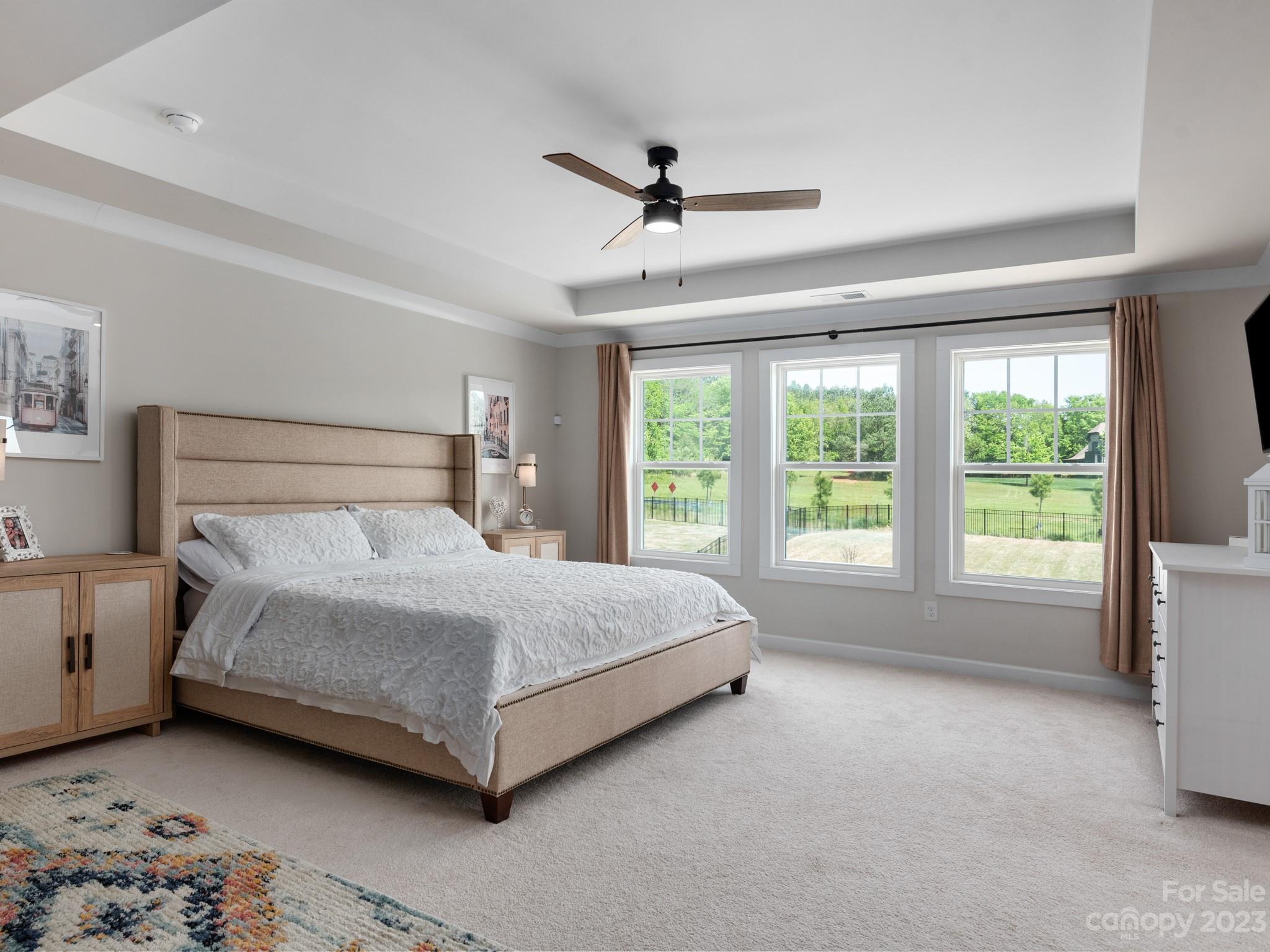 413 Hudson Place Davidson, NC 28036 - Photo 15 of 38 a bedroom with a bed lamp and a large window
