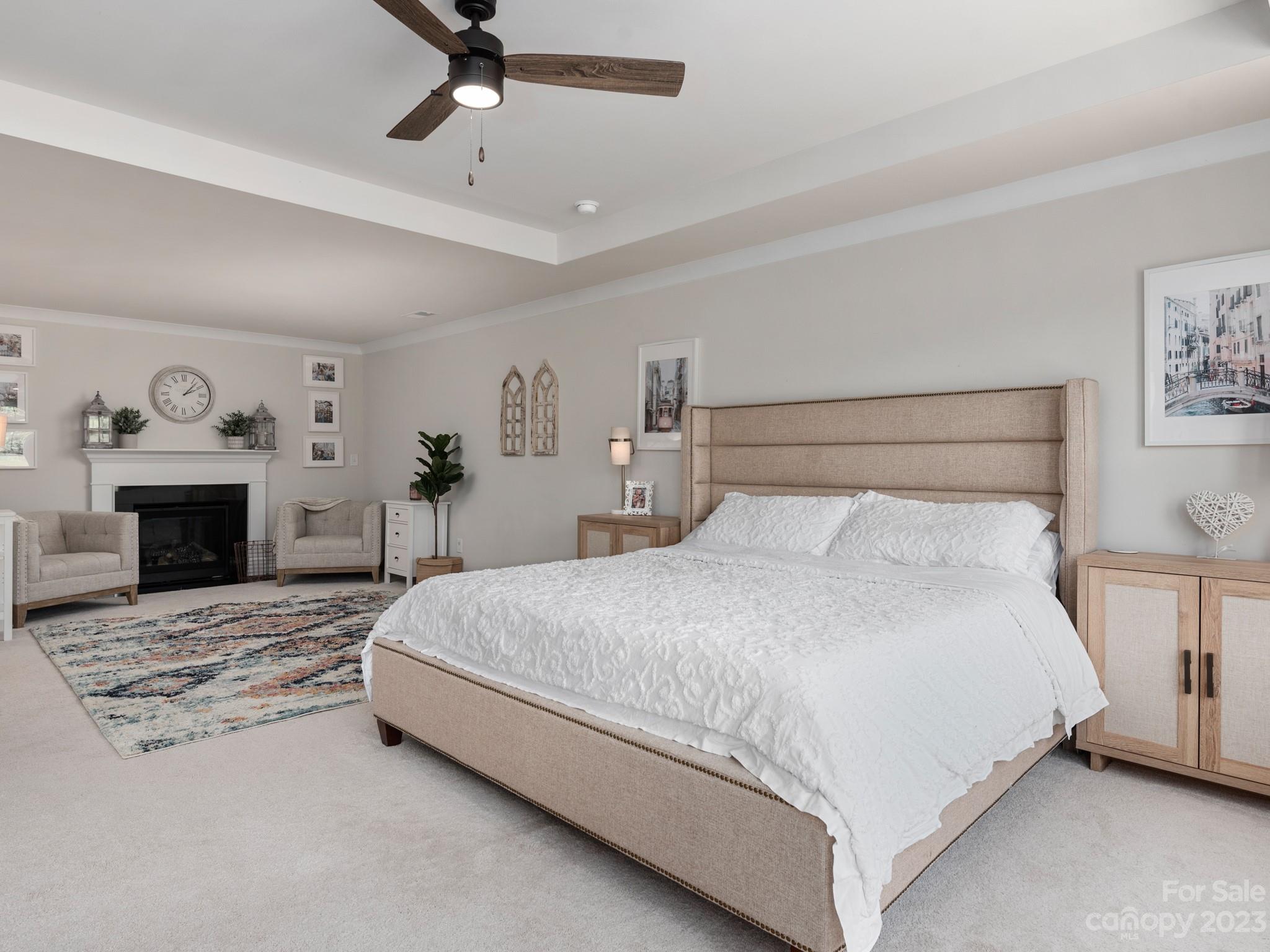 413 Hudson Place Davidson, NC 28036 - Photo 16 of 38 a bedroom with a large bed and a fireplace