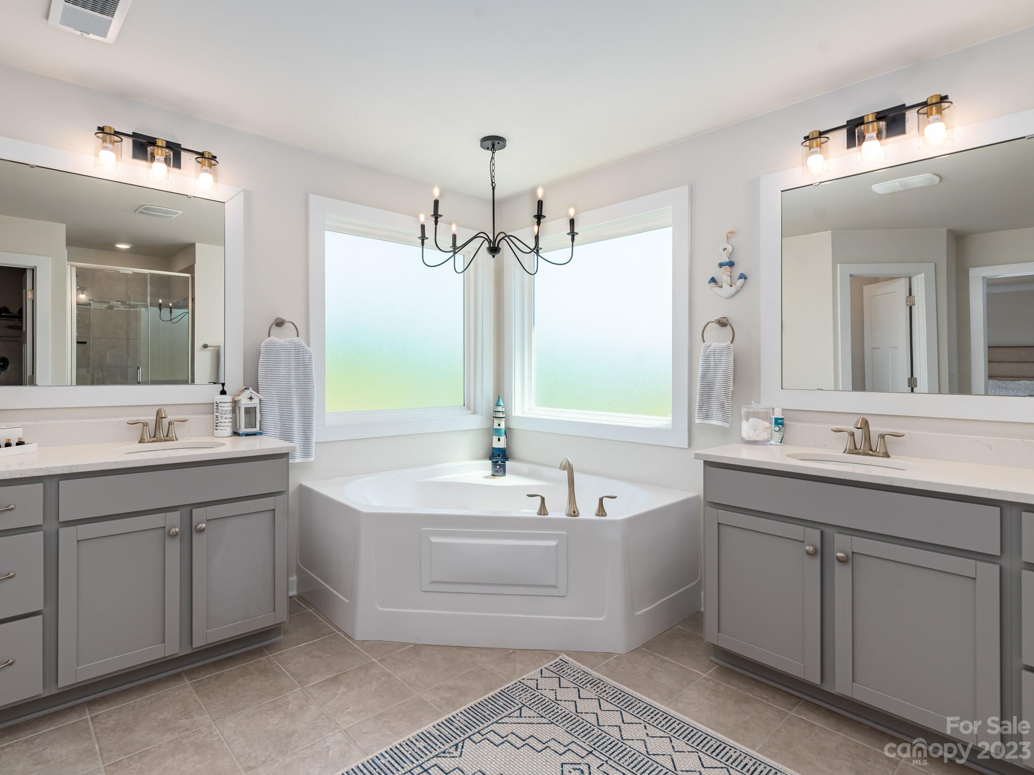 413 Hudson Place Davidson, NC 28036 - Photo 18 of 38 a spacious bathroom with a double vanity sink mirror and bathtub