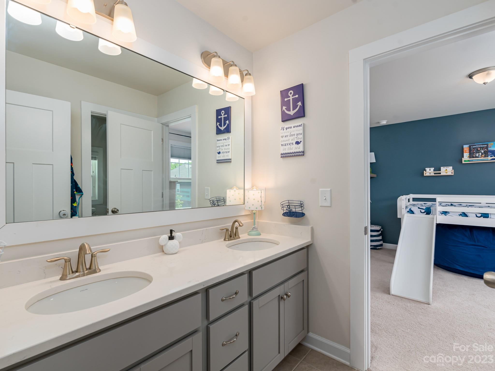 413 Hudson Place Davidson, NC 28036 - Photo 22 of 38 a bathroom with a double vanity sink and a mirror