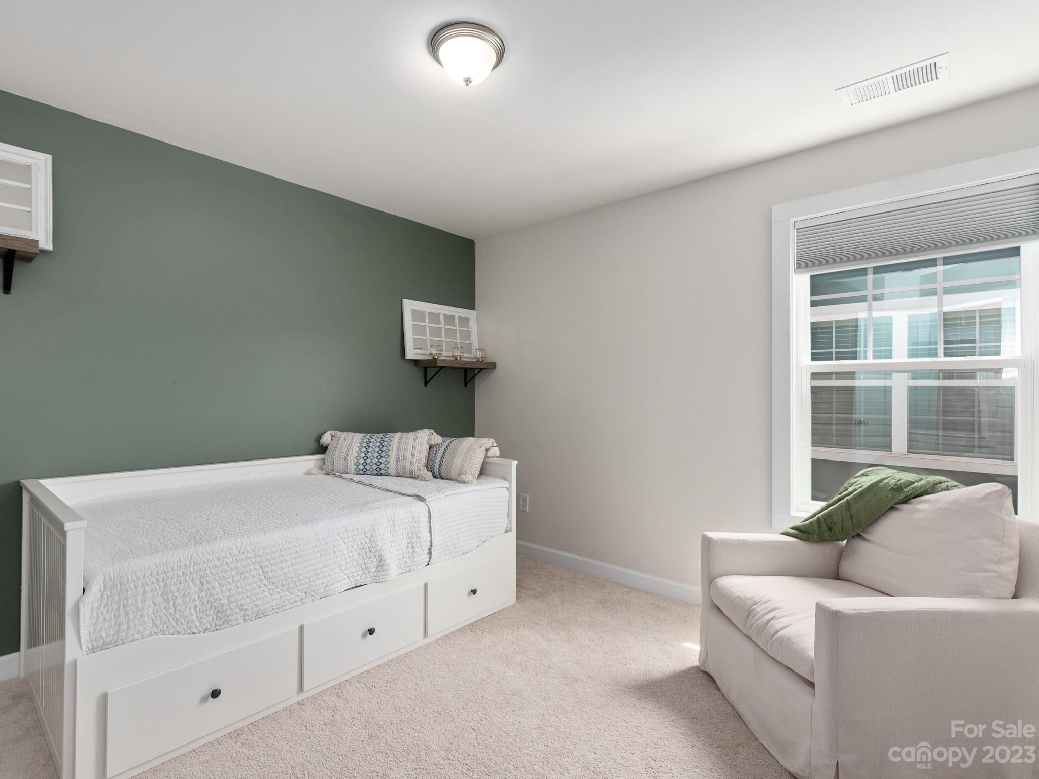 413 Hudson Place Davidson, NC 28036 - Photo 24 of 38 a bedroom with a bed and a window