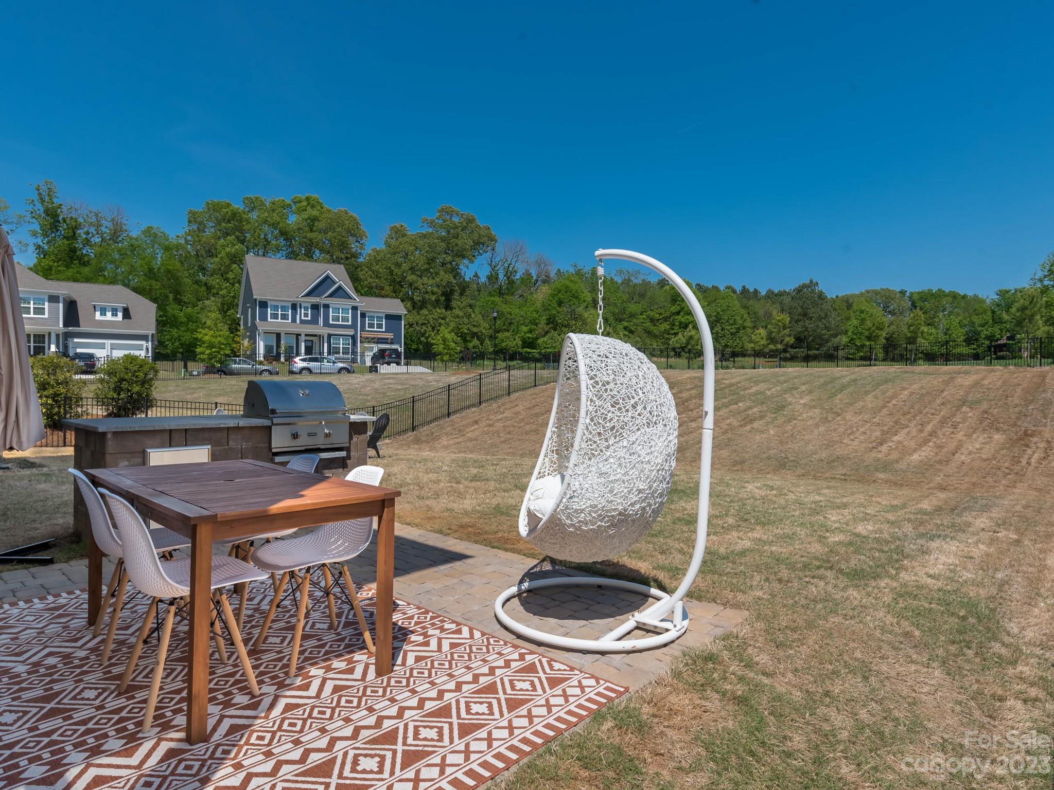 413 Hudson Place Davidson, NC 28036 - Photo 29 of 38 a backyard of a house with table and chairs