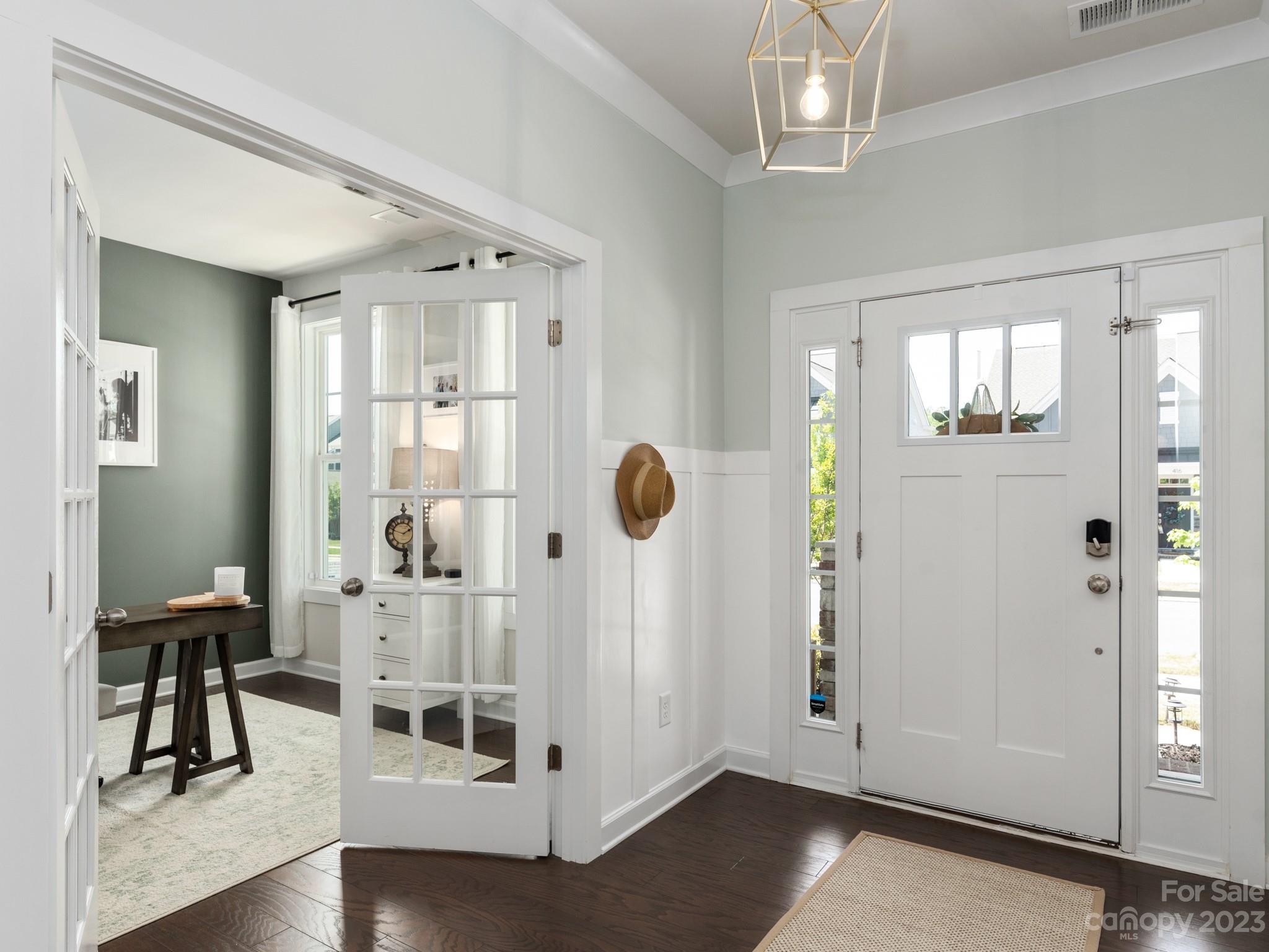 413 Hudson Place Davidson, NC 28036 - Photo 5 of 38 a view of a hallway with wooden floor and windows