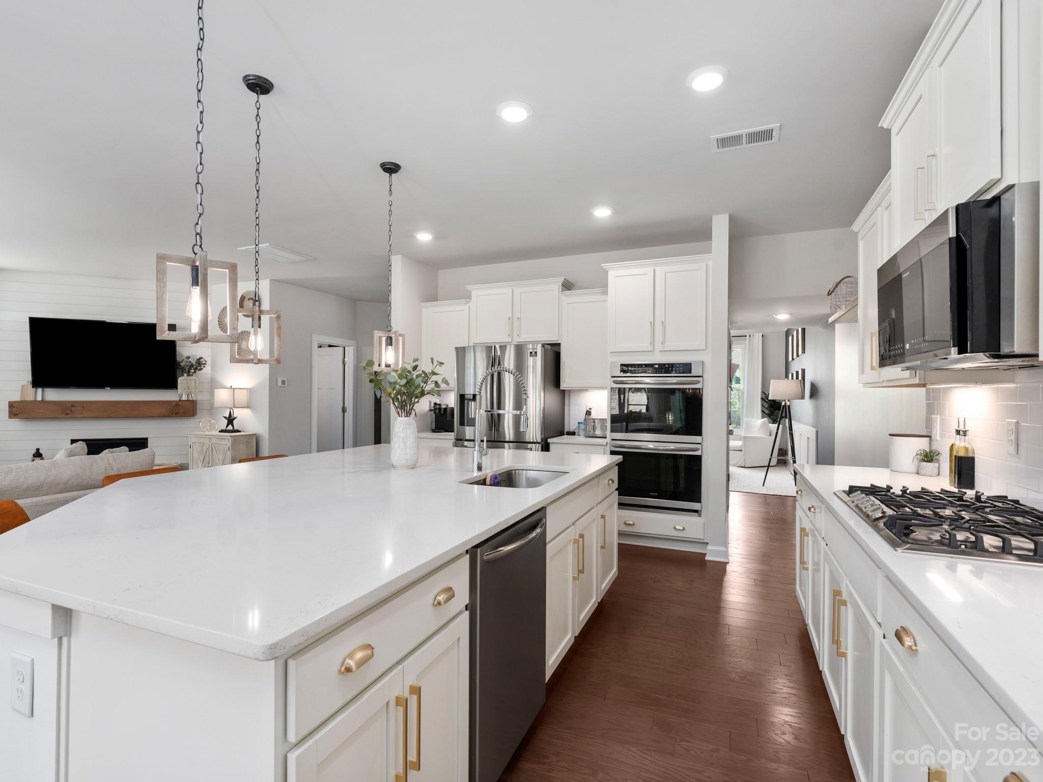 413 Hudson Place Davidson, NC 28036 - Photo 8 of 38 a large kitchen with kitchen island a sink stainless steel appliances and cabinets