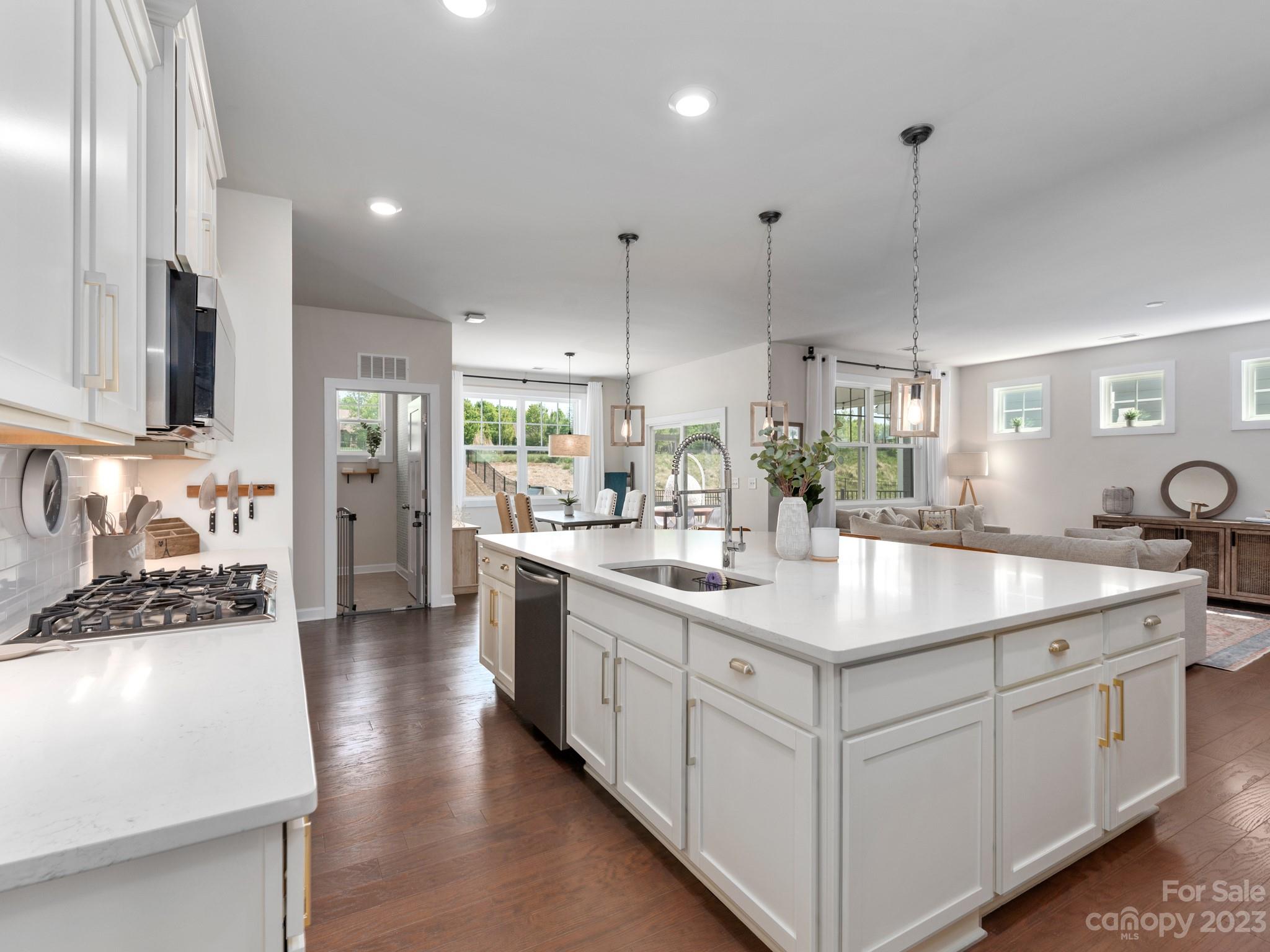 413 Hudson Place Davidson, NC 28036 - Photo 9 of 38 a kitchen with kitchen island a sink stove and refrigerator