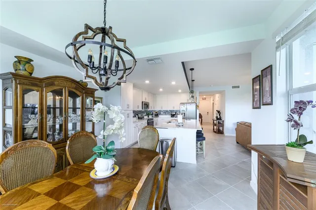 a kitchen with stainless steel appliances a dining table and chairs
