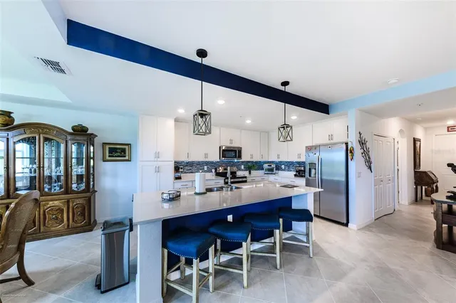 a kitchen with cabinets stainless steel appliances and a counter space