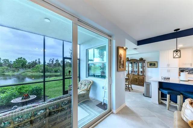 a living room with furniture and a floor to ceiling window