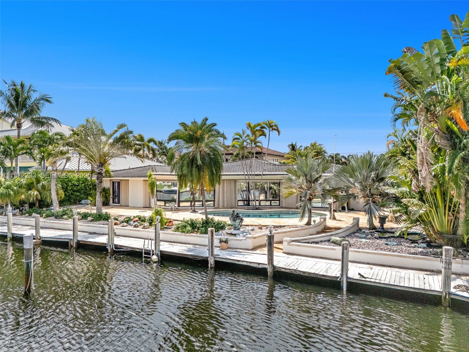 2321 Northeast 35th Street Lighthouse Point, FL 33064 - Photo 3 of 5 a view of house with swimming pool and lake view