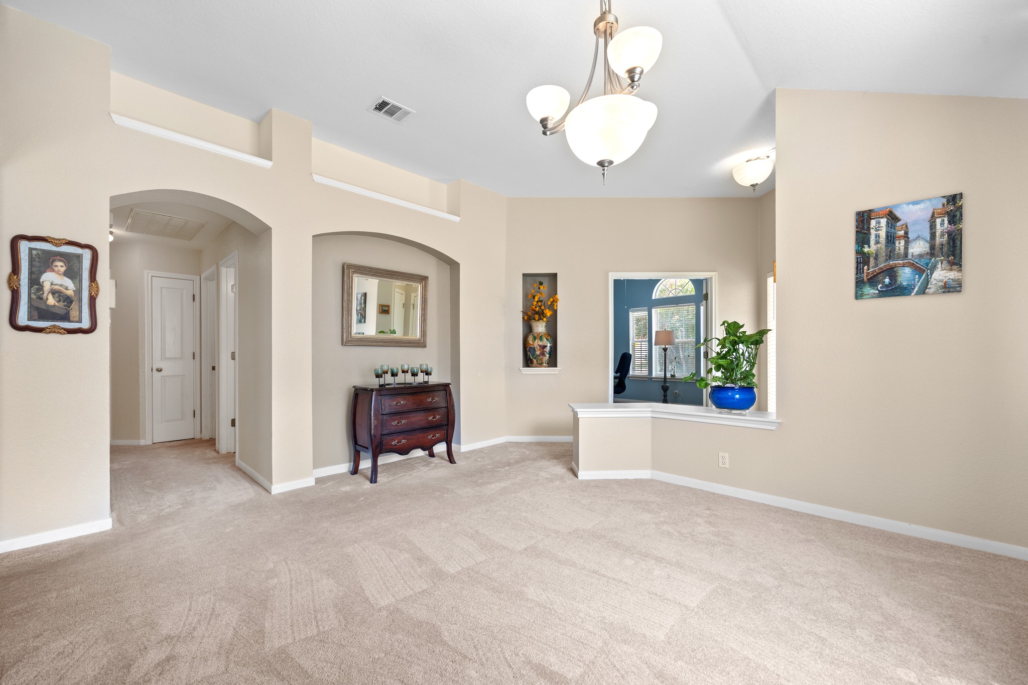 1108 Springbrook Road Pflugerville, TX 78660 - Photo 9 of 37 A generously sized living area offers ample space for relaxation and entertaining, illuminated by overhead lighting.