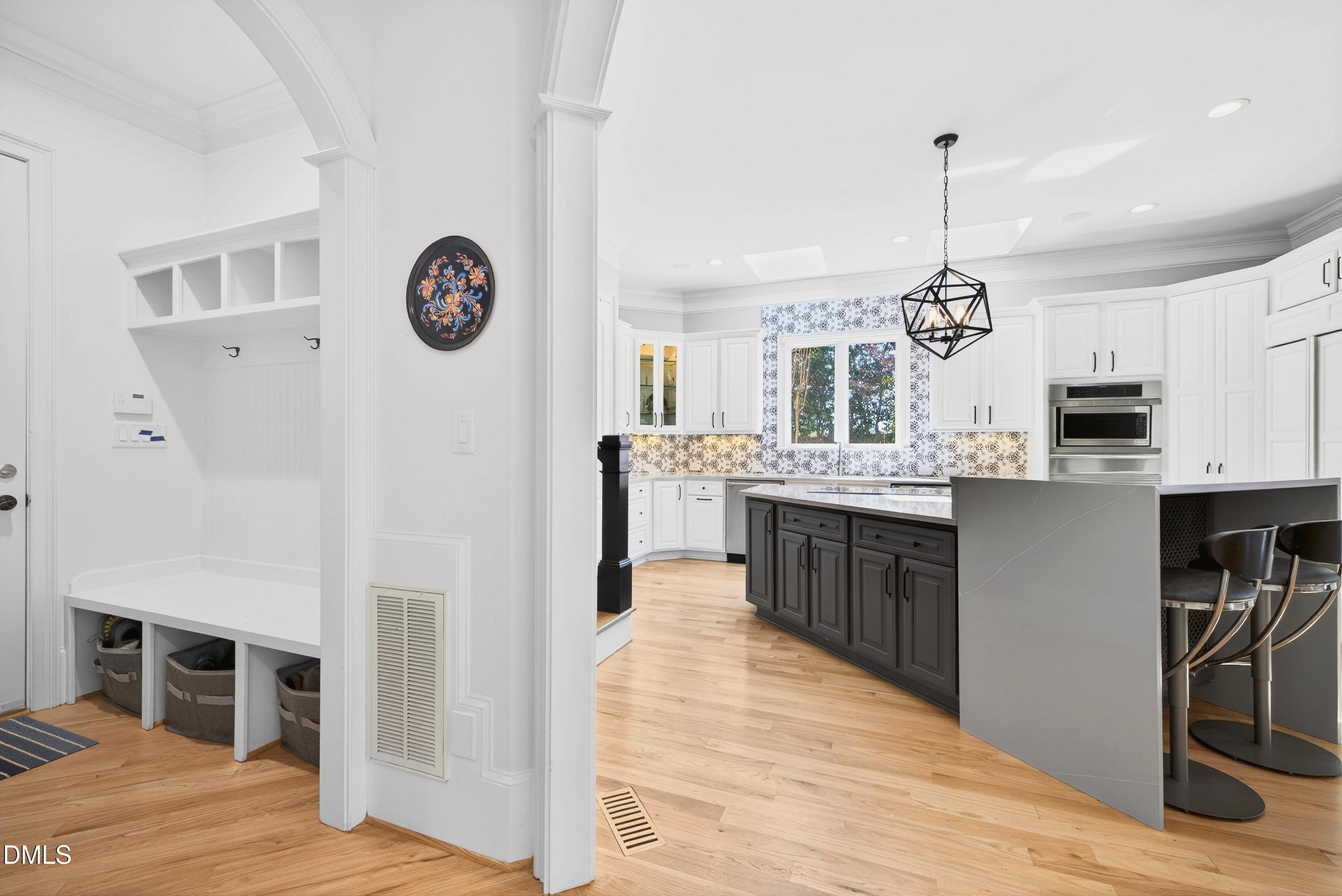 6701 Foxfire Place Raleigh, NC 27615 - Photo 24 of 67 a large kitchen with stainless steel appliances kitchen island granite countertop a refrigerator a stove a sink and a wooden floors