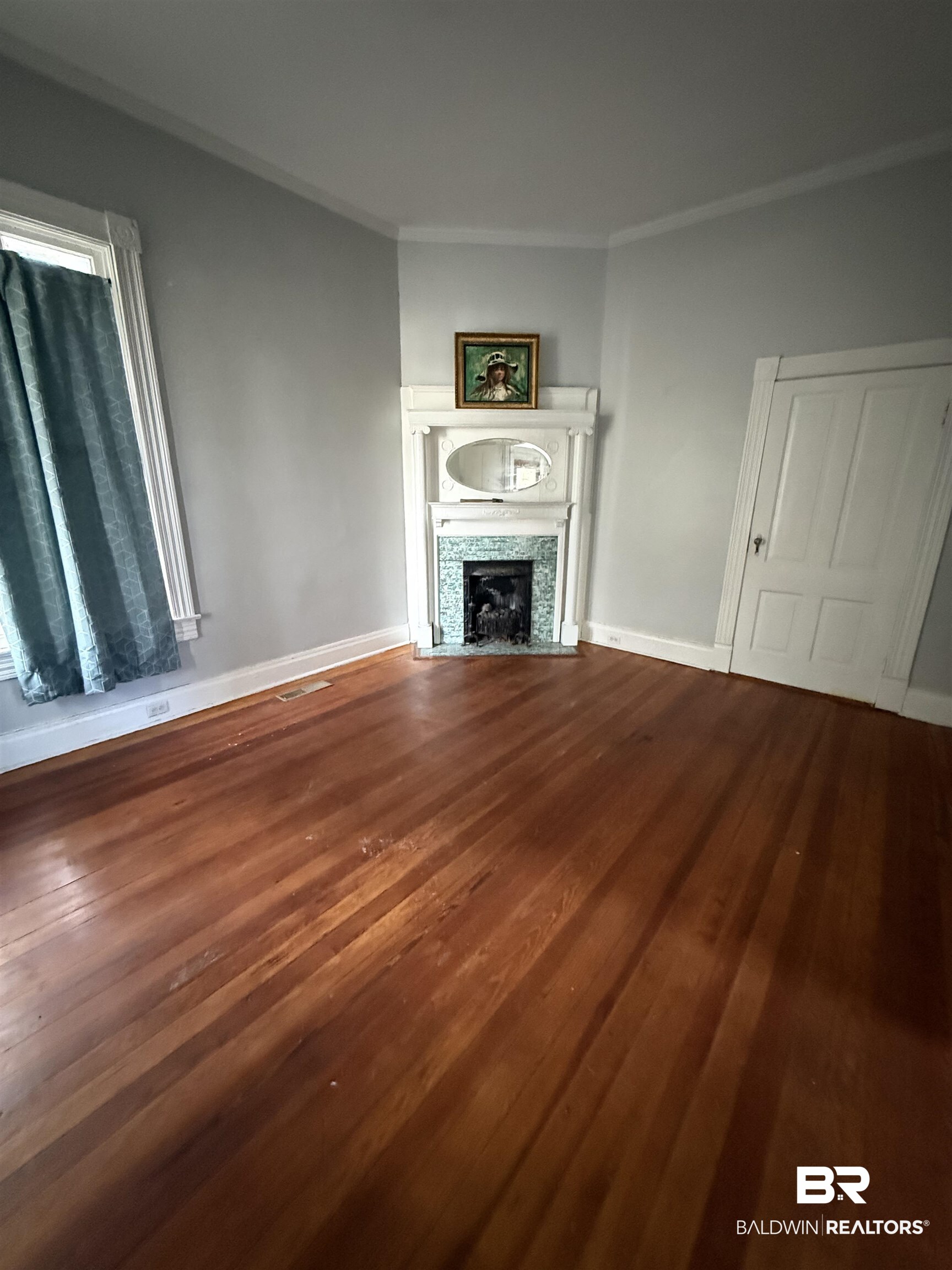 352 South Ann Street Mobile, AL 36604 - Photo 4 of 20 Unfurnished living room with dark wood-type flooring, a tile fireplace, and ornamental molding