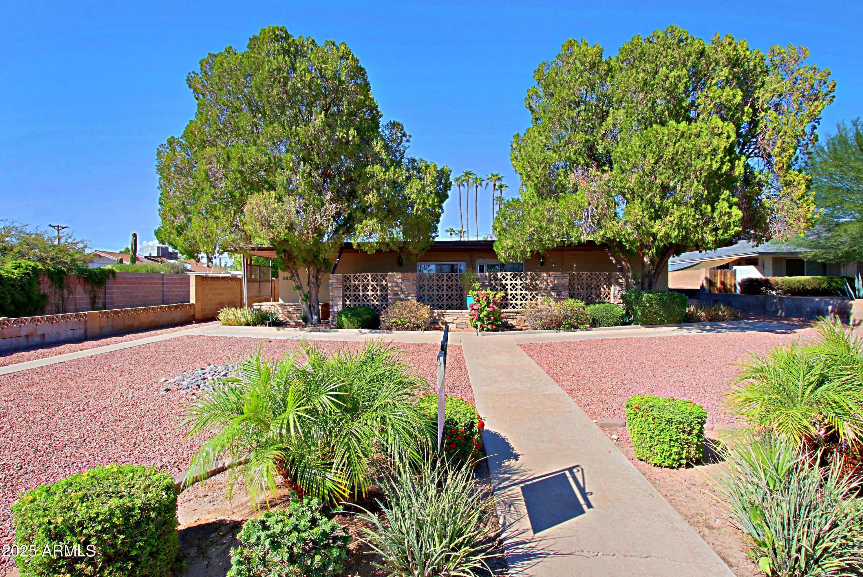 3618 East Montecito Avenue, Unit 2 Phoenix, AZ 85018 - Photo 1 of 17 a swimming pool with outdoor seating and garden