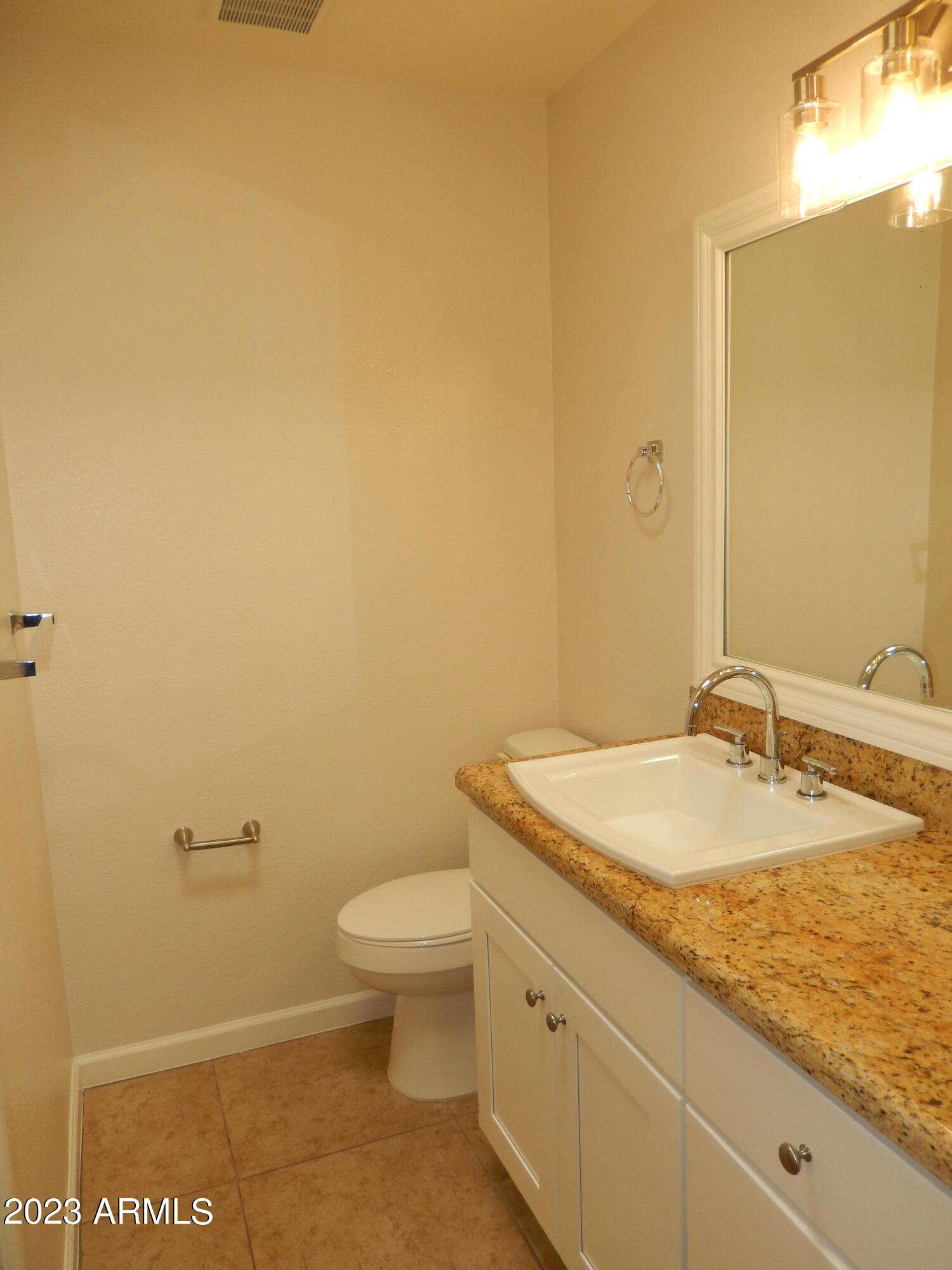 3618 East Montecito Avenue, Unit 2 Phoenix, AZ 85018 - Photo 12 of 17 a bathroom with a granite countertop sink and a mirror