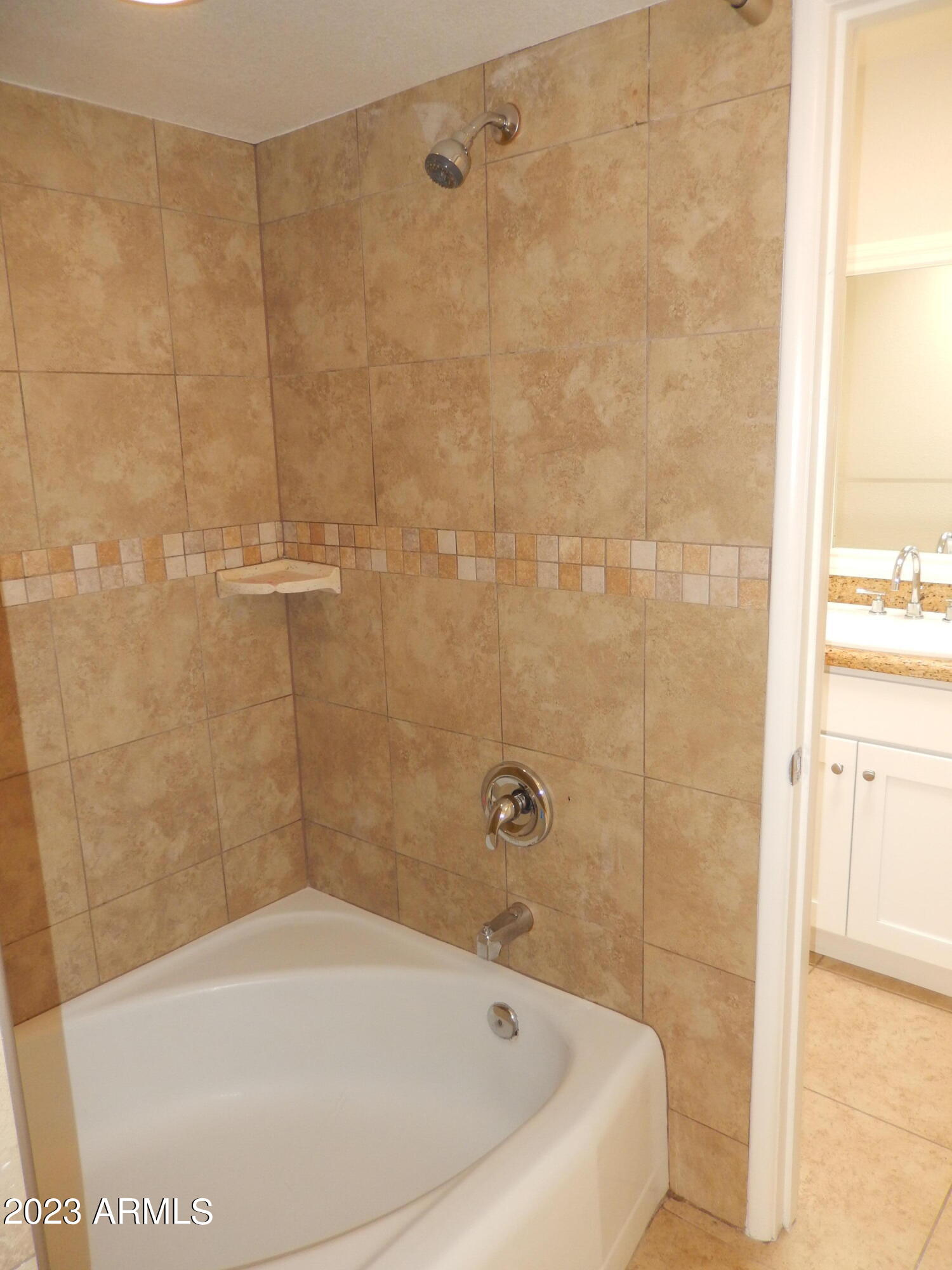 3618 East Montecito Avenue, Unit 2 Phoenix, AZ 85018 - Photo 13 of 17 a white bath tub sitting next to a white sink and a shower