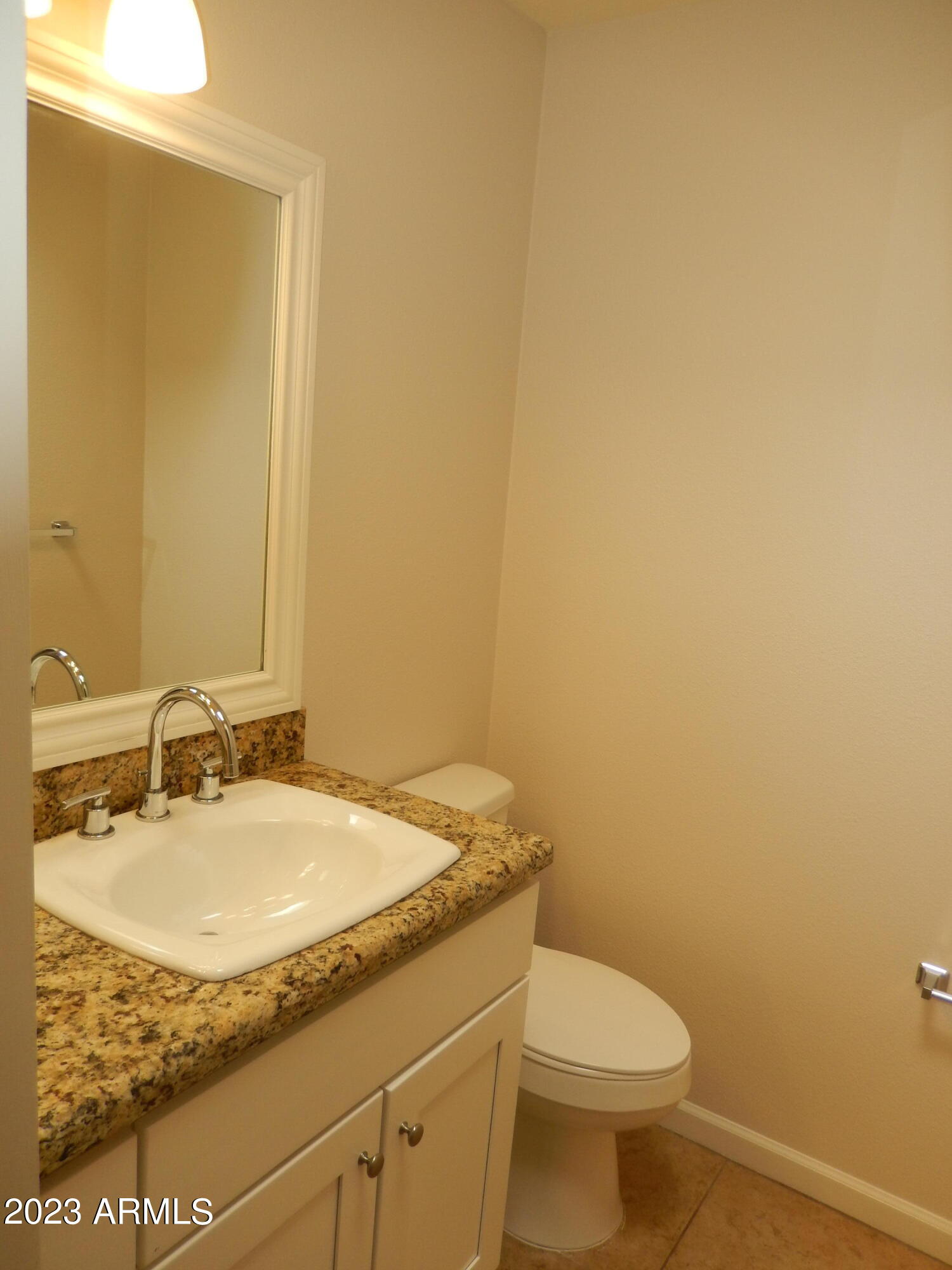 3618 East Montecito Avenue, Unit 2 Phoenix, AZ 85018 - Photo 14 of 17 a bathroom with a granite countertop sink and a mirror