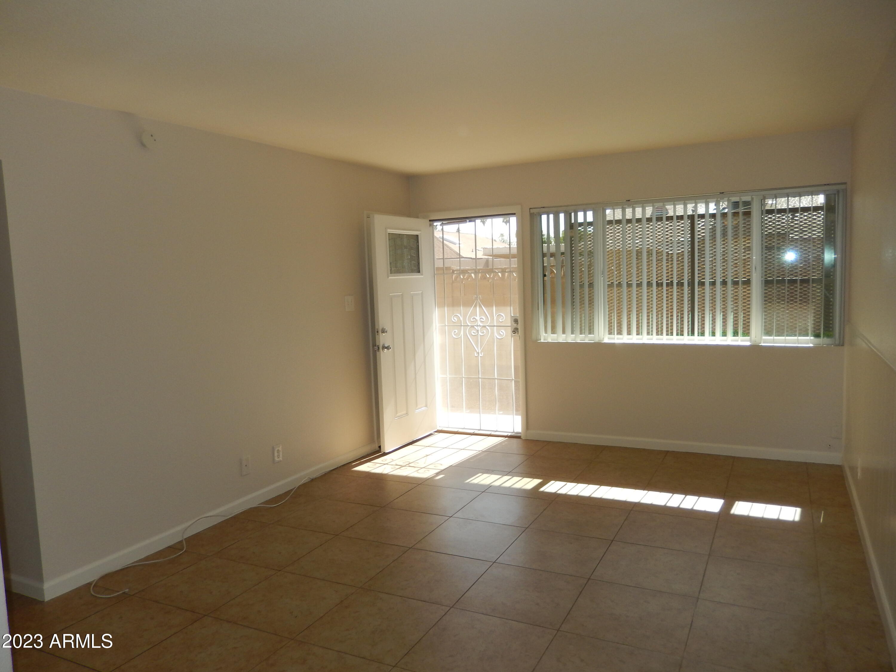 3618 East Montecito Avenue, Unit 2 Phoenix, AZ 85018 - Photo 3 of 17 a view of an empty room with a window
