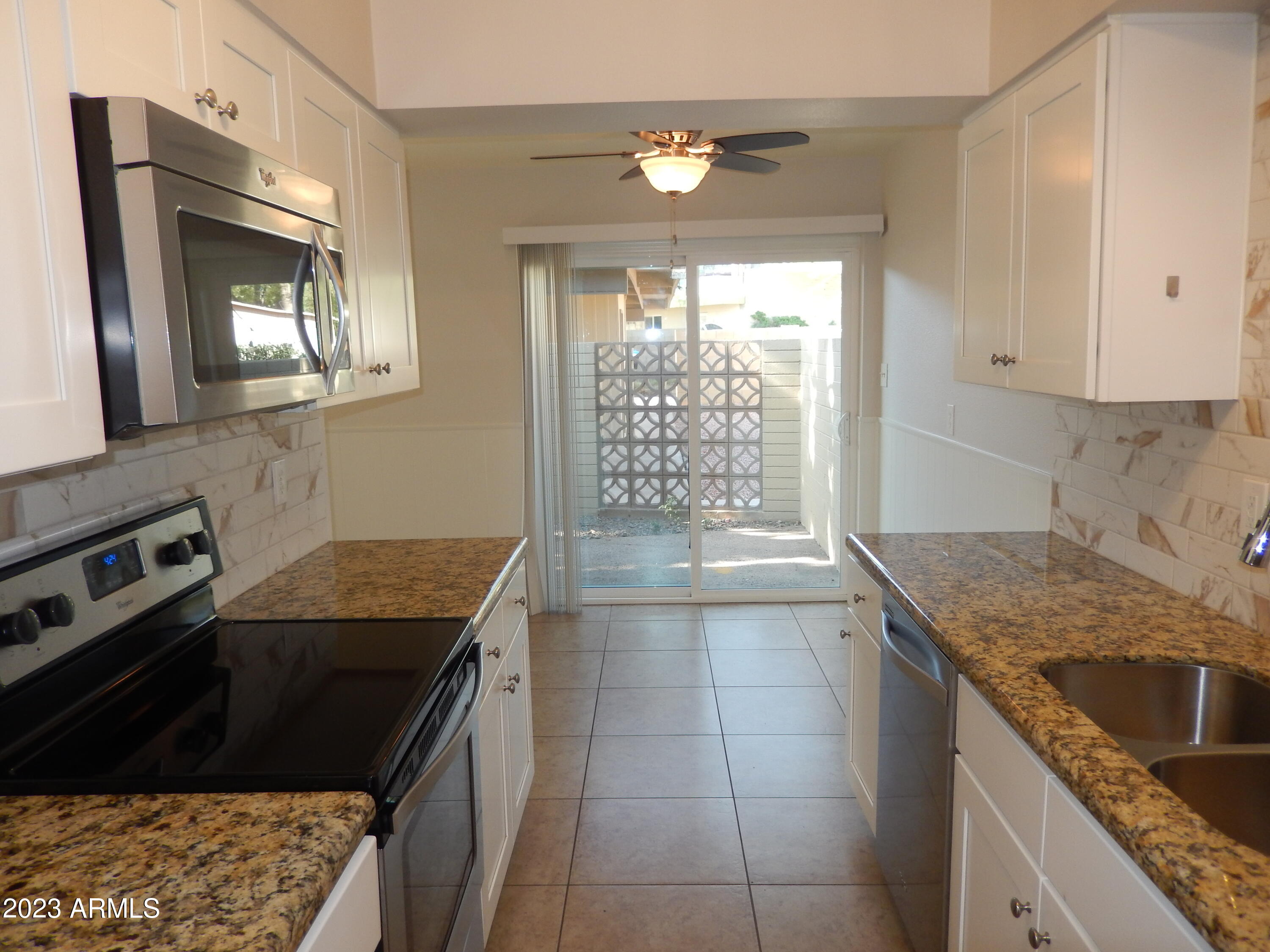3618 East Montecito Avenue, Unit 2 Phoenix, AZ 85018 - Photo 5 of 17 a kitchen that has a sink a stove and a table in it