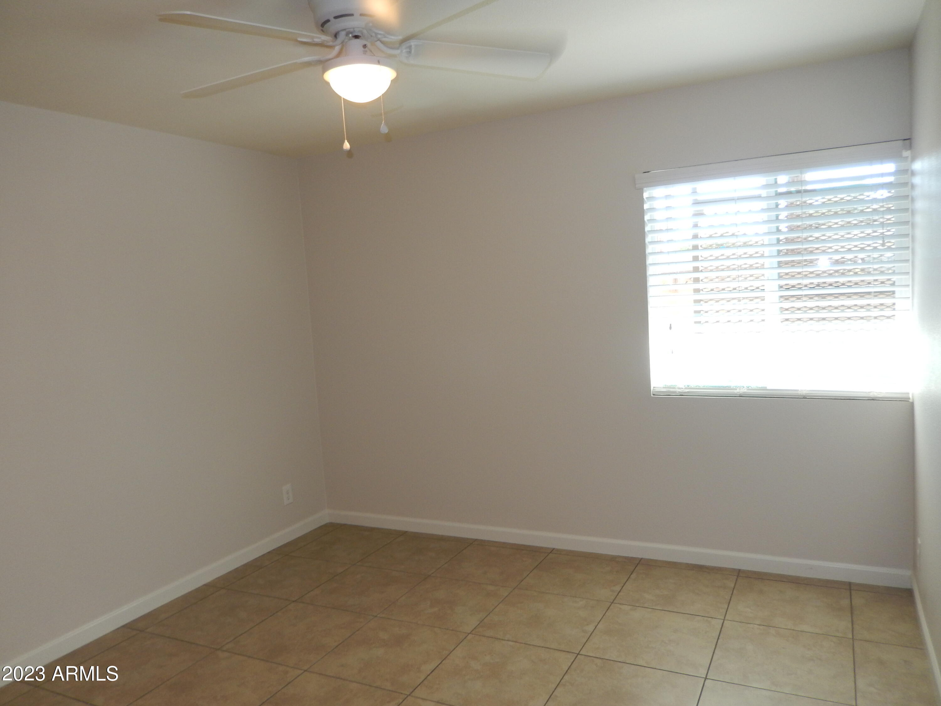 3618 East Montecito Avenue, Unit 2 Phoenix, AZ 85018 - Photo 8 of 17 a view of an empty room with a window