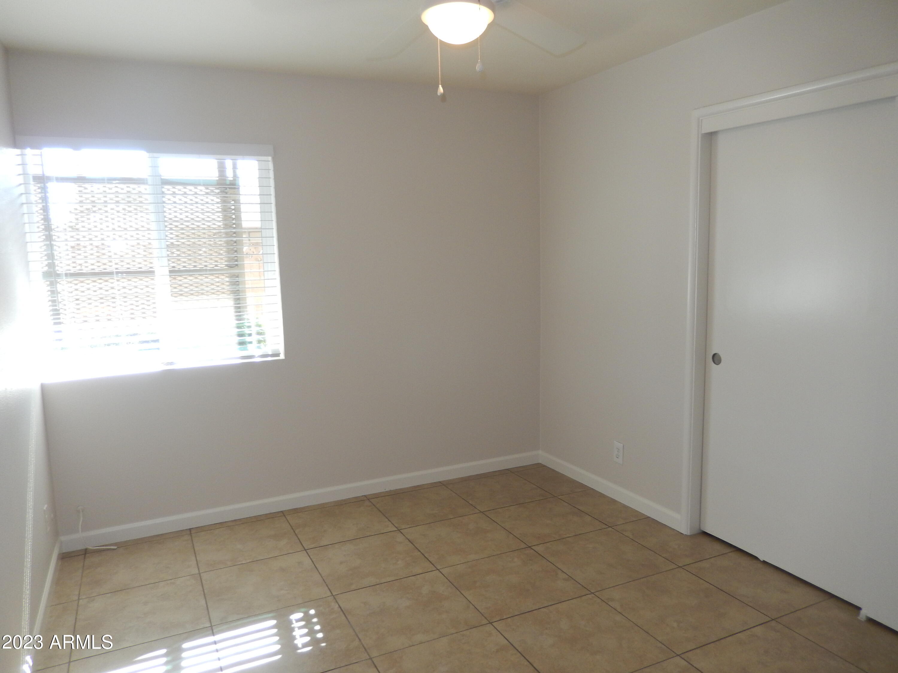 3618 East Montecito Avenue, Unit 2 Phoenix, AZ 85018 - Photo 10 of 17 an empty room with a window