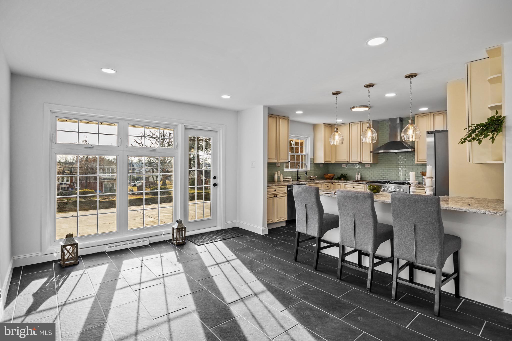 1221 Huntingdon Pike Huntingdon Valley, PA 19006 - Photo 12 of 48 a kitchen with stainless steel appliances granite countertop a refrigerator a sink a stove and white cabinets with wooden floor