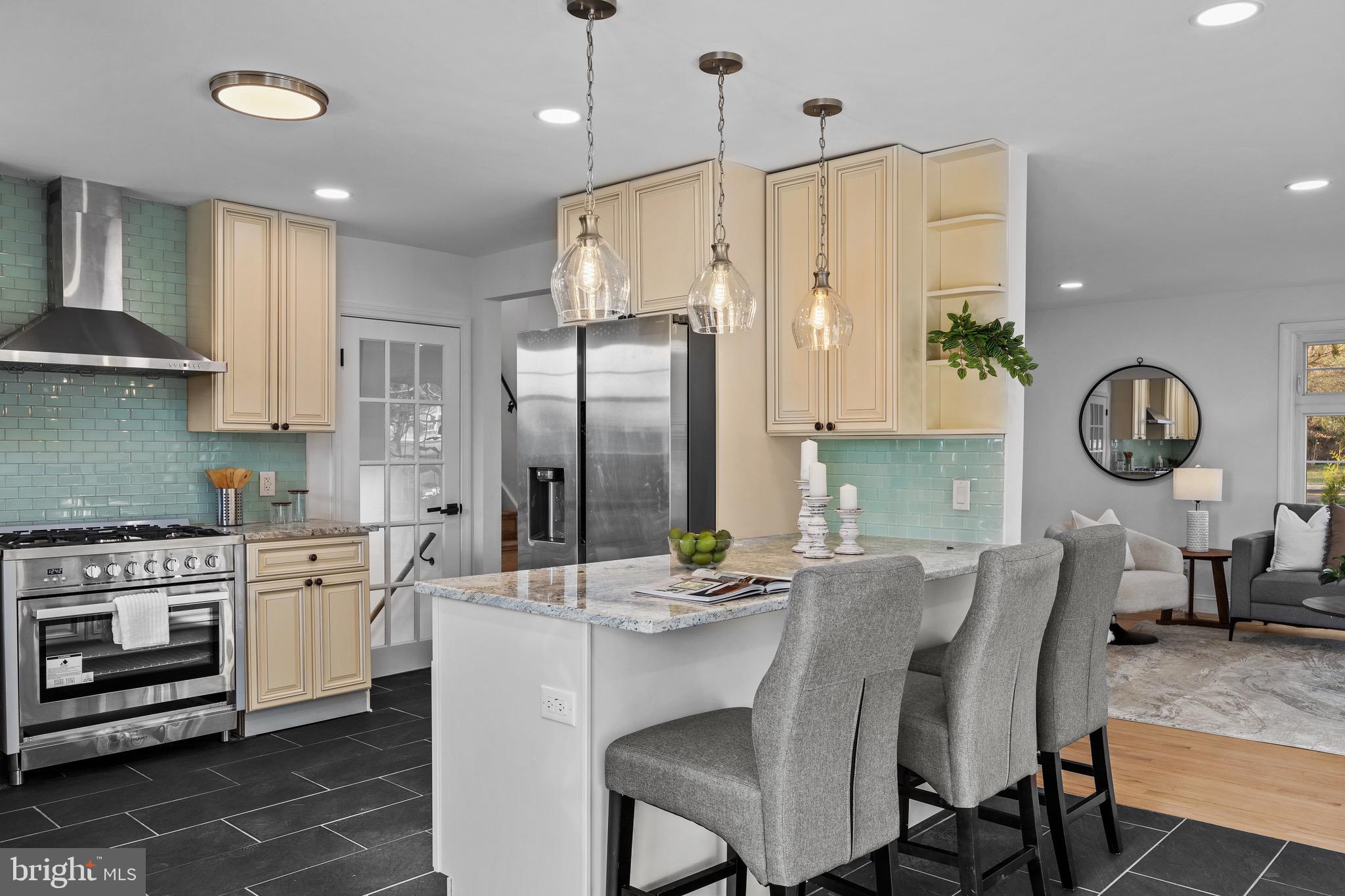 1221 Huntingdon Pike Huntingdon Valley, PA 19006 - Photo 14 of 48 a kitchen with stainless steel appliances kitchen island granite countertop a refrigerator a stove a sink with a dining table and chairs