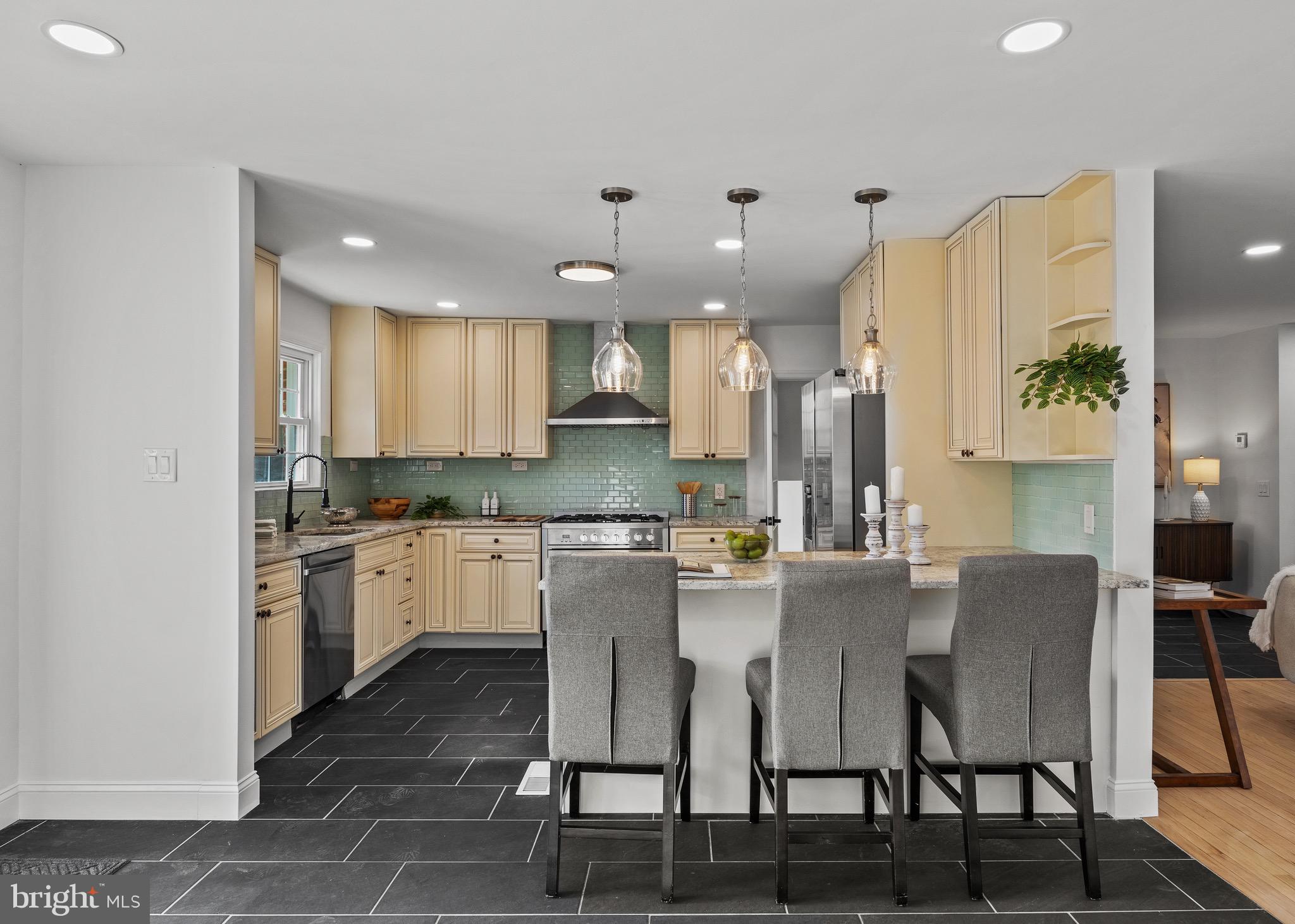 1221 Huntingdon Pike Huntingdon Valley, PA 19006 - Photo 15 of 48 a kitchen with kitchen island granite countertop a table and chairs in it