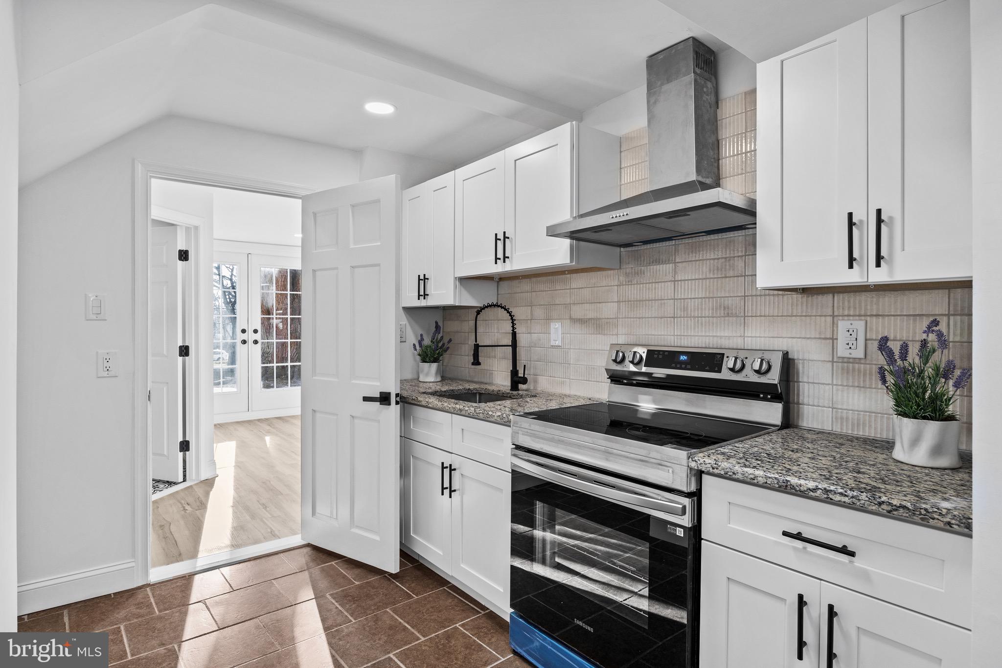 1221 Huntingdon Pike Huntingdon Valley, PA 19006 - Photo 39 of 48 a kitchen with stainless steel appliances granite countertop a stove a sink and a refrigerator