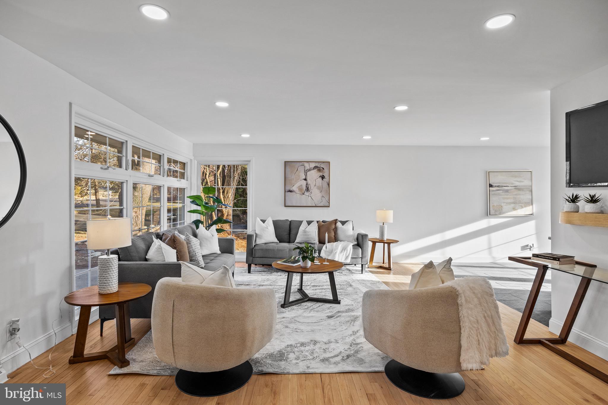 1221 Huntingdon Pike Huntingdon Valley, PA 19006 - Photo 7 of 48 a living room with furniture a flat screen tv and a floor to ceiling window
