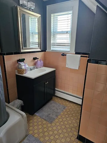 a bathroom with a sink a mirror and a bathtub