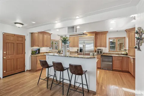 a kitchen with stainless steel appliances granite countertop counter top space and wooden floor