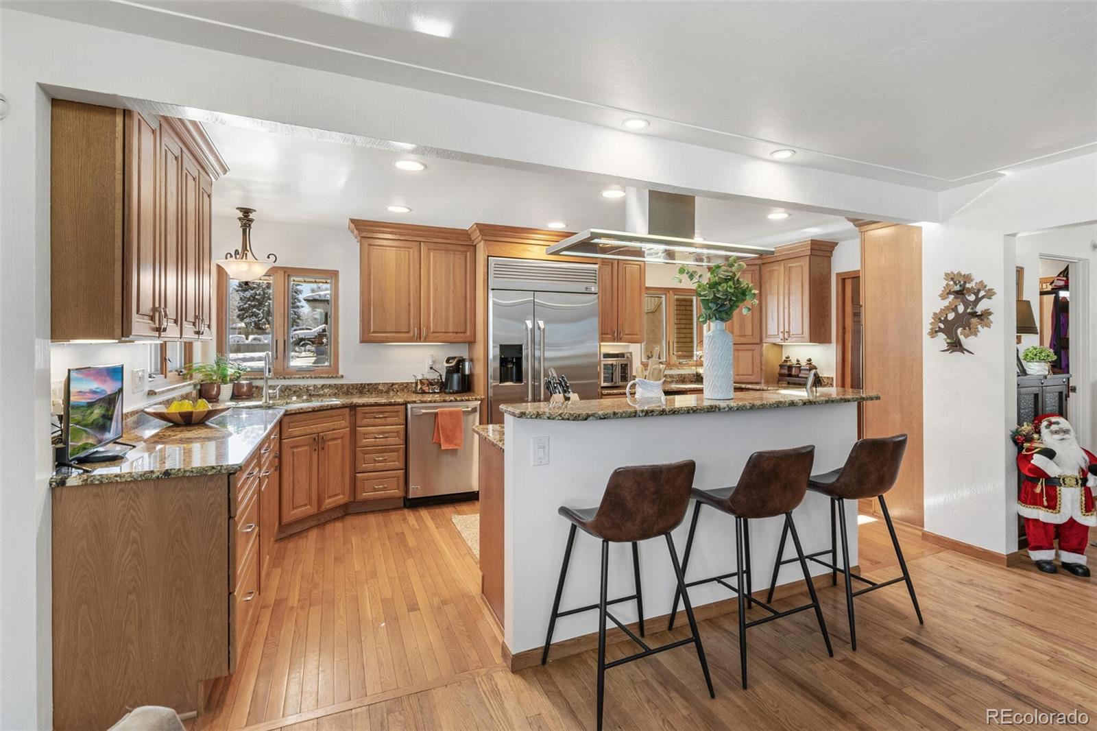 4155 Ingalls Street Wheat Ridge, CO 80033 - Photo 12 of 47 a kitchen with stainless steel appliances granite countertop counter top space and wooden floor