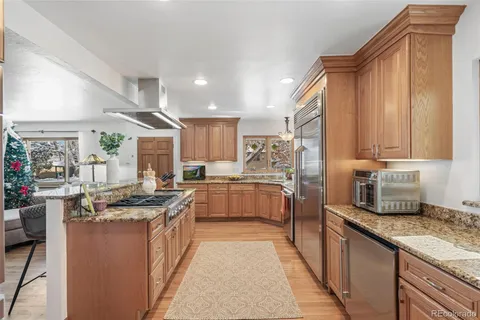 a kitchen with stainless steel appliances granite countertop a stove oven and a refrigerator