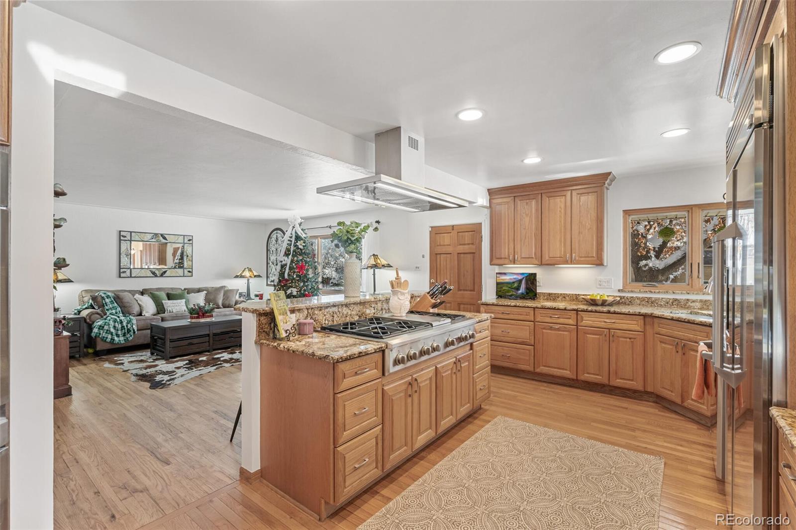4155 Ingalls Street Wheat Ridge, CO 80033 - Photo 14 of 47 a kitchen with stainless steel appliances granite countertop a stove oven and a refrigerator