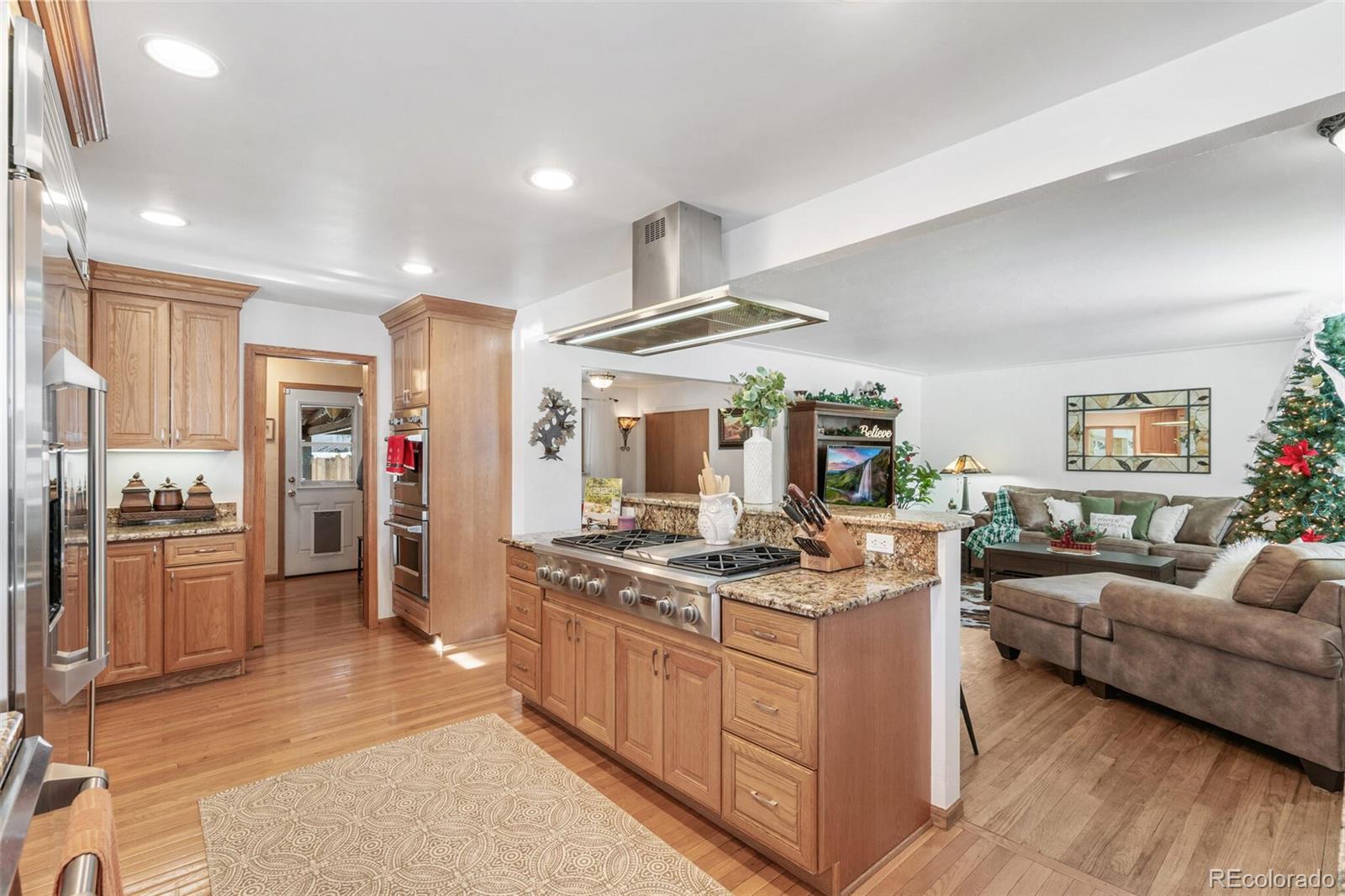 4155 Ingalls Street Wheat Ridge, CO 80033 - Photo 15 of 47 a kitchen with stainless steel appliances granite countertop a stove oven and a refrigerator