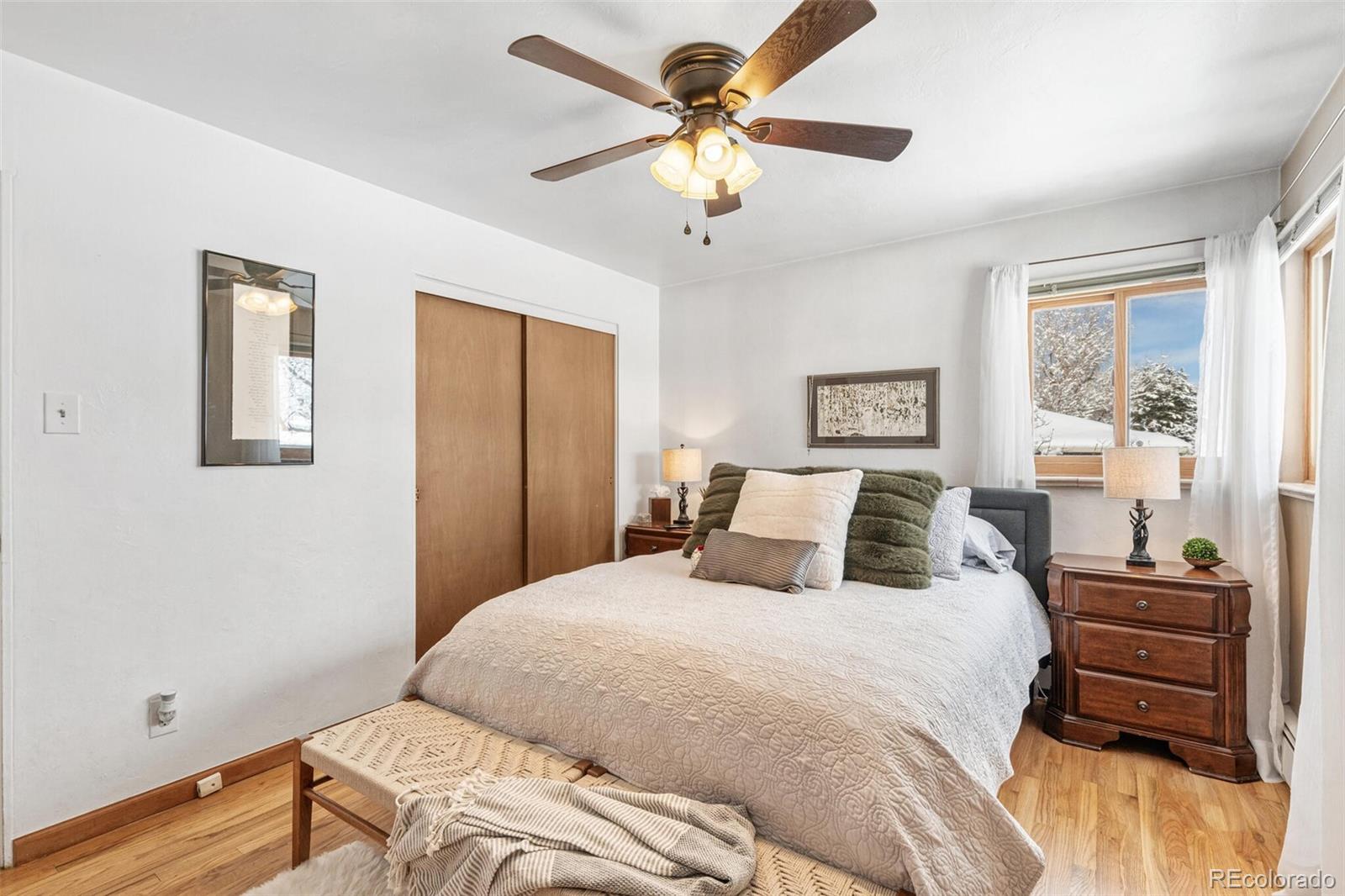 4155 Ingalls Street Wheat Ridge, CO 80033 - Photo 20 of 47 a bedroom with a bed and a chandelier