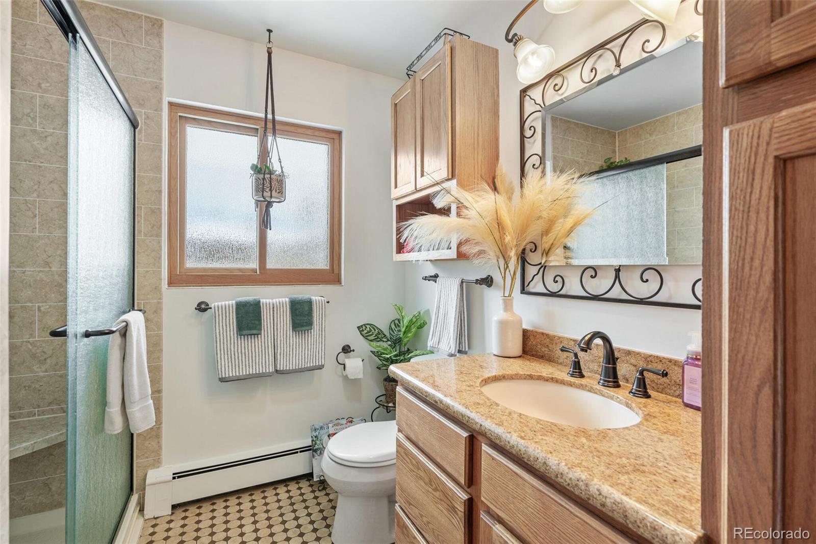 4155 Ingalls Street Wheat Ridge, CO 80033 - Photo 21 of 47 a bathroom with a granite countertop sink and a mirror
