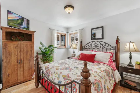 a living room with furniture a piano and a window