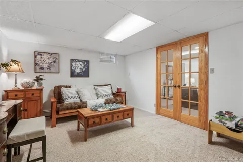 a bedroom with a bed and a lamp on dresser